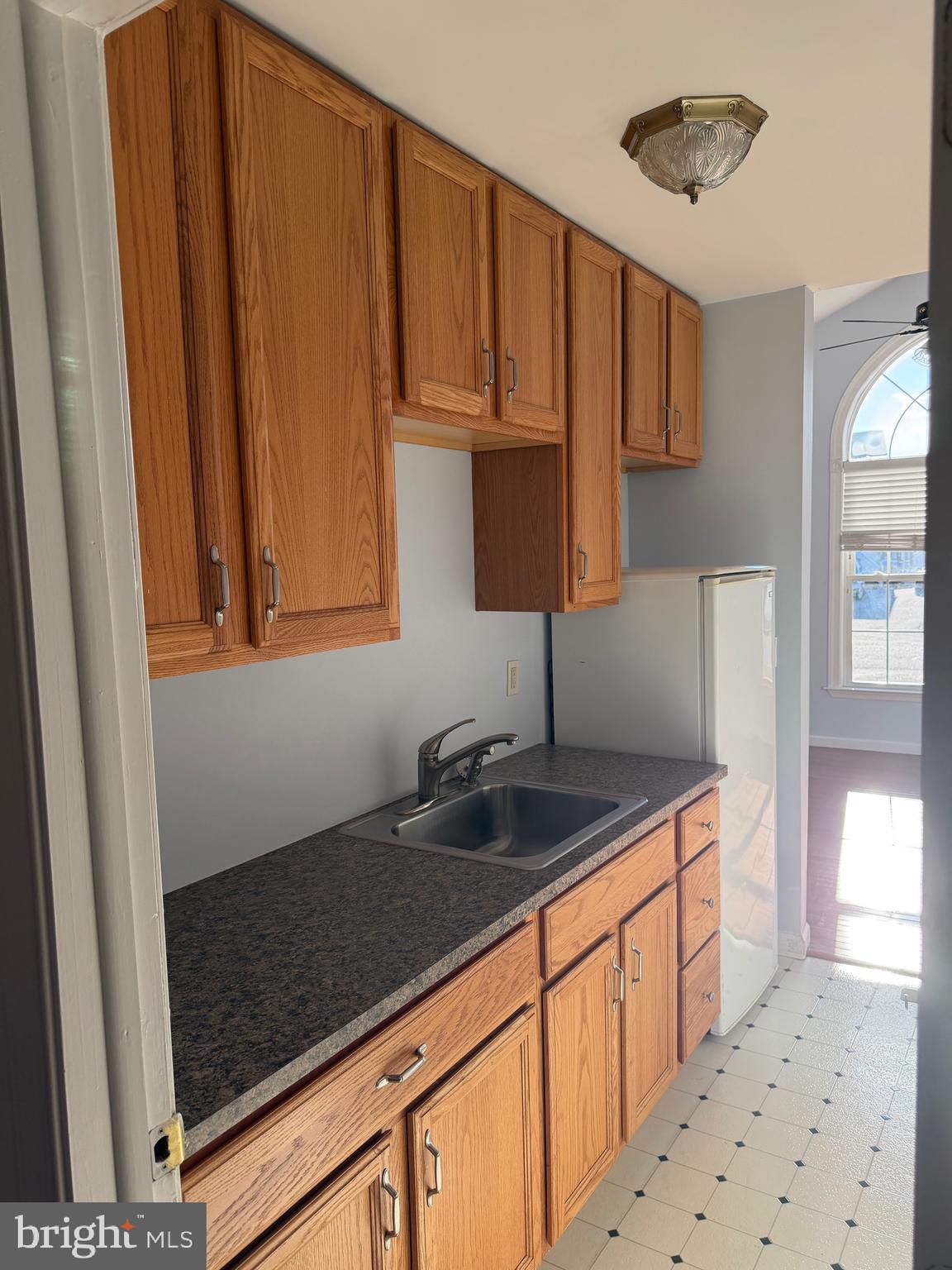32841 East Riga Drive Ocean View, DE 19970 - Photo 13 of 33 a kitchen with granite countertop a sink cabinets and window