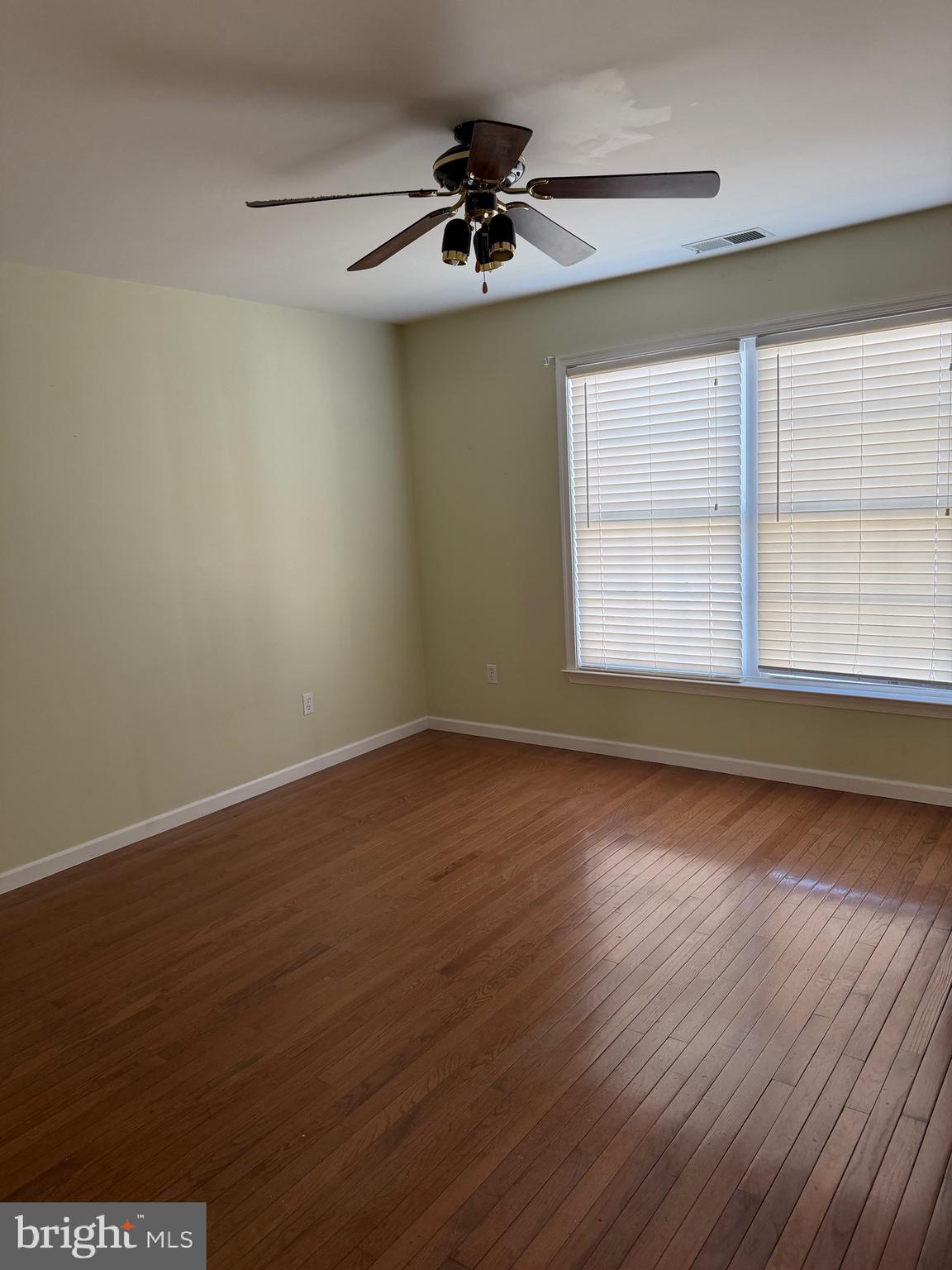 32841 East Riga Drive Ocean View, DE 19970 - Photo 16 of 33 an empty room with wooden floor and windows