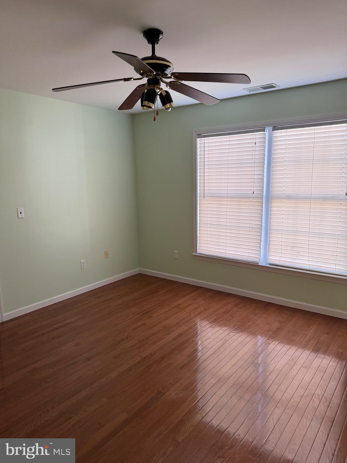 32841 East Riga Drive Ocean View, DE 19970 - Photo 18 of 33 an empty room with wooden floor fan and windows