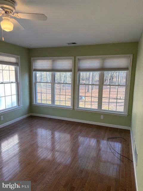 32841 East Riga Drive Ocean View, DE 19970 - Photo 26 of 33 an empty room with wooden floor and windows
