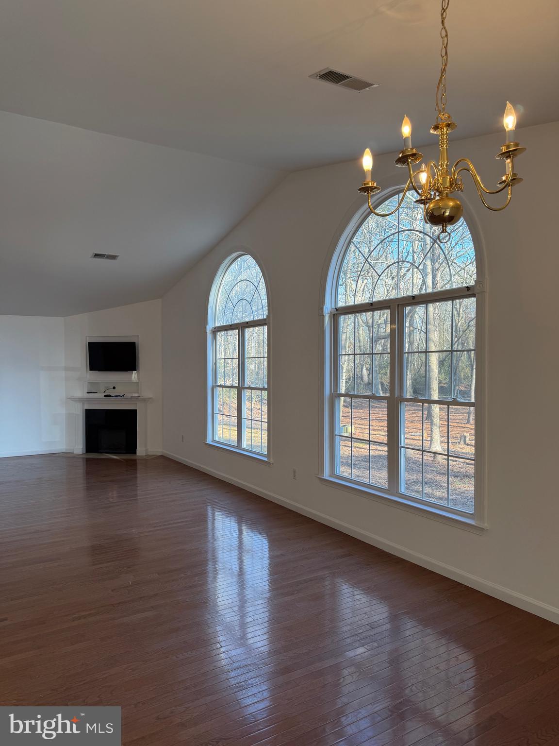 32841 East Riga Drive Ocean View, DE 19970 - Photo 3 of 33 an empty room with wooden floor chandelier and windows