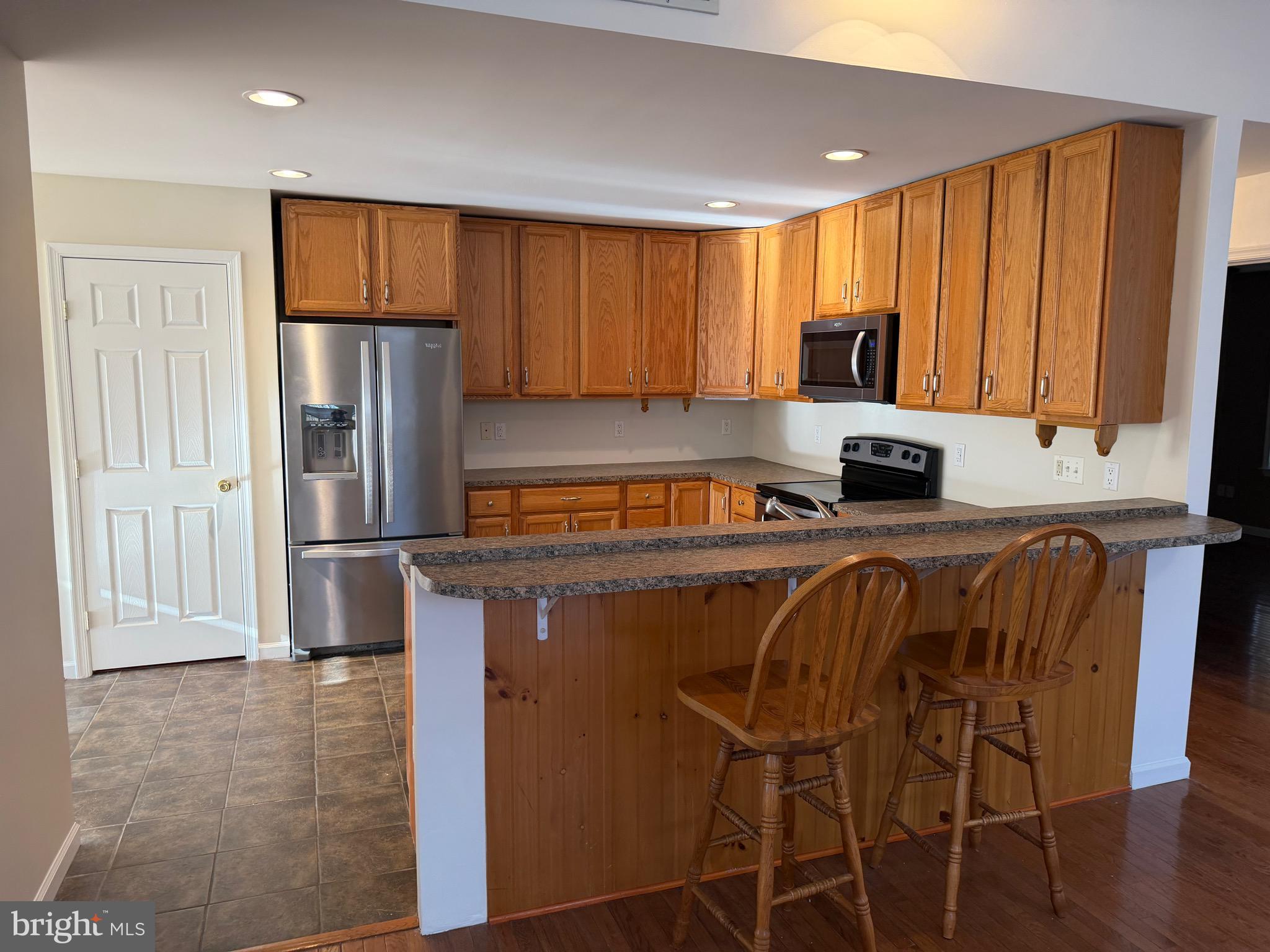 32841 East Riga Drive Ocean View, DE 19970 - Photo 7 of 33 a kitchen with stainless steel appliances a refrigerator and a stove top oven