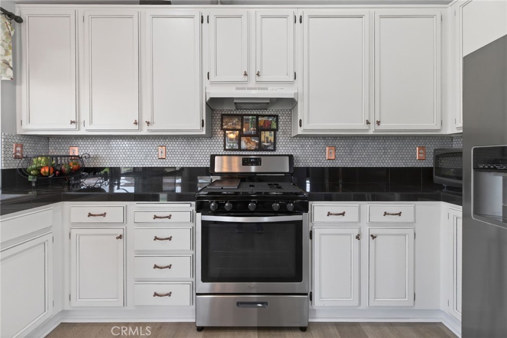 19584 Jill Court Riverside, CA 92508 - Photo 7 of 31 a kitchen with white cabinets and appliances