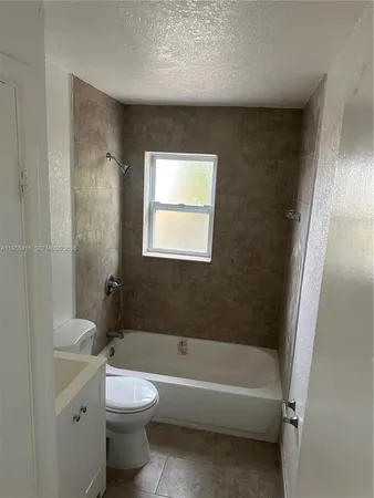 a bathroom with a toilet a sink and bathtub