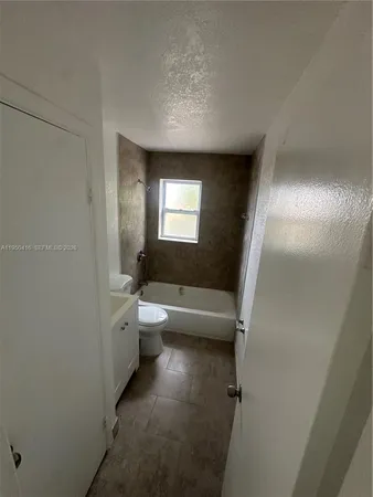 a bathroom with a bathtub and toilet