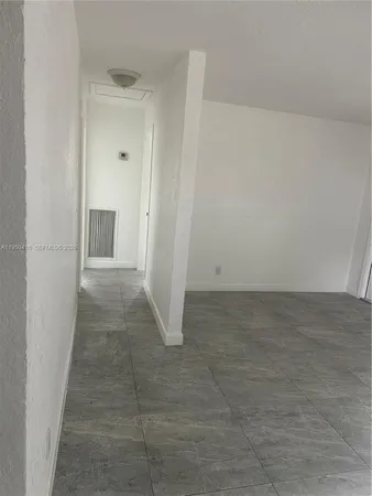 a kitchen with granite countertop a sink and cabinets