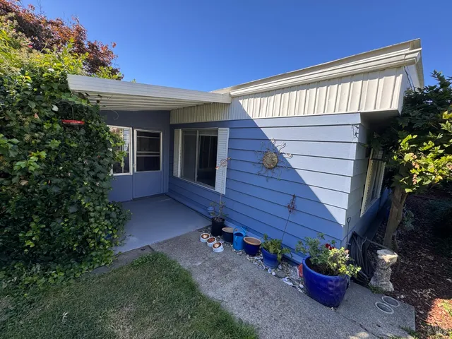 a view of a house with a backyard