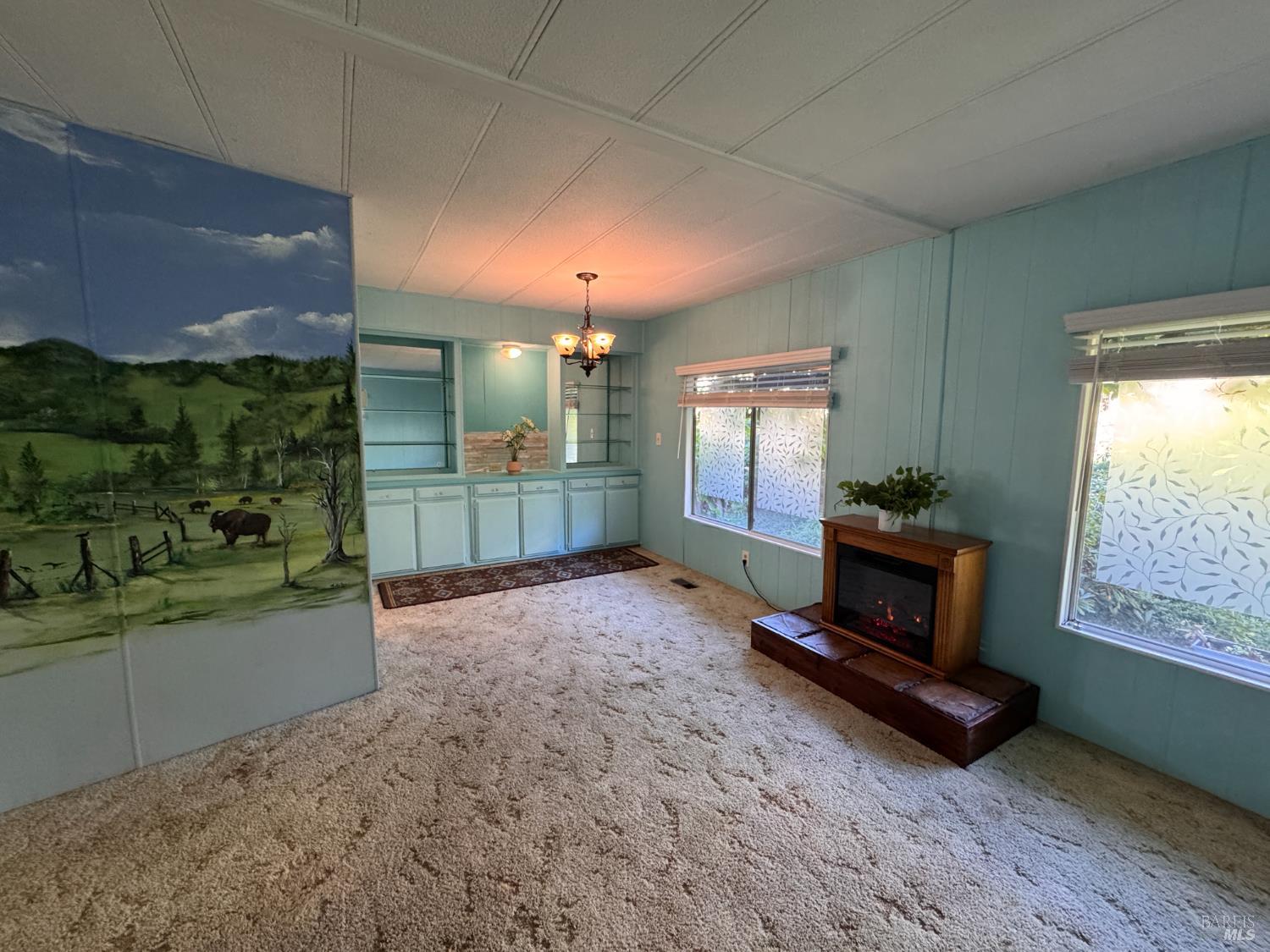 28 Springhill Court Santa Rosa, CA 95409 - Photo 10 of 36 a living room with furniture a flat screen tv and a fireplace