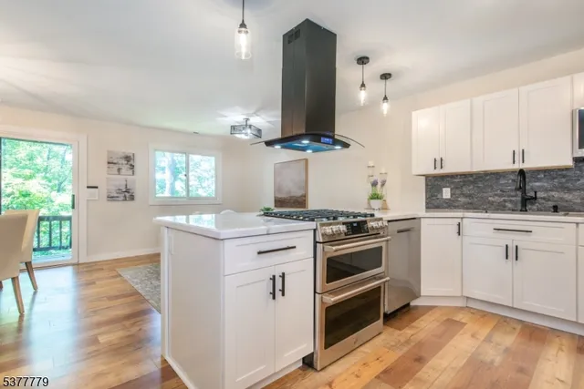 a kitchen with stainless steel appliances granite countertop a stove and a sink