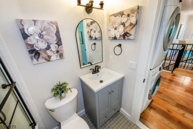 a bathroom with a toilet a sink and a mirror