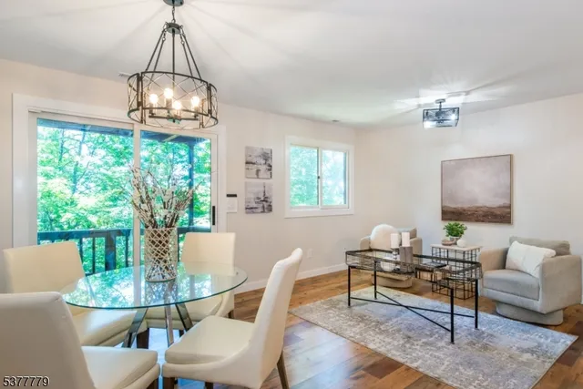 a living room with patio a table and a chandelier