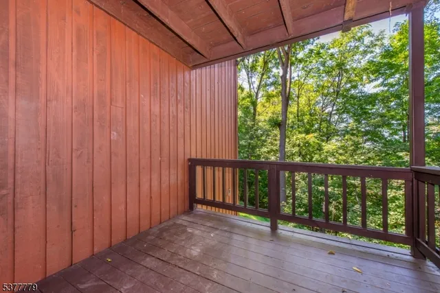 a view of a porch with wooden floor and outdoor space