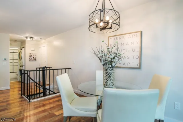 a view of a dining room with furniture wooden floor and chandelier