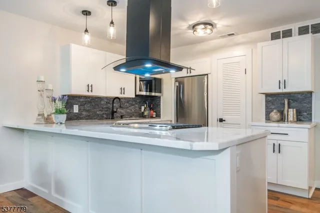 a kitchen with stainless steel appliances a sink a stove and a refrigerator