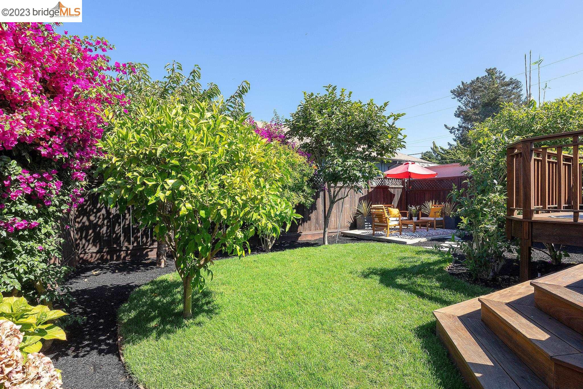 a view of a house with backyard sitting area and garden