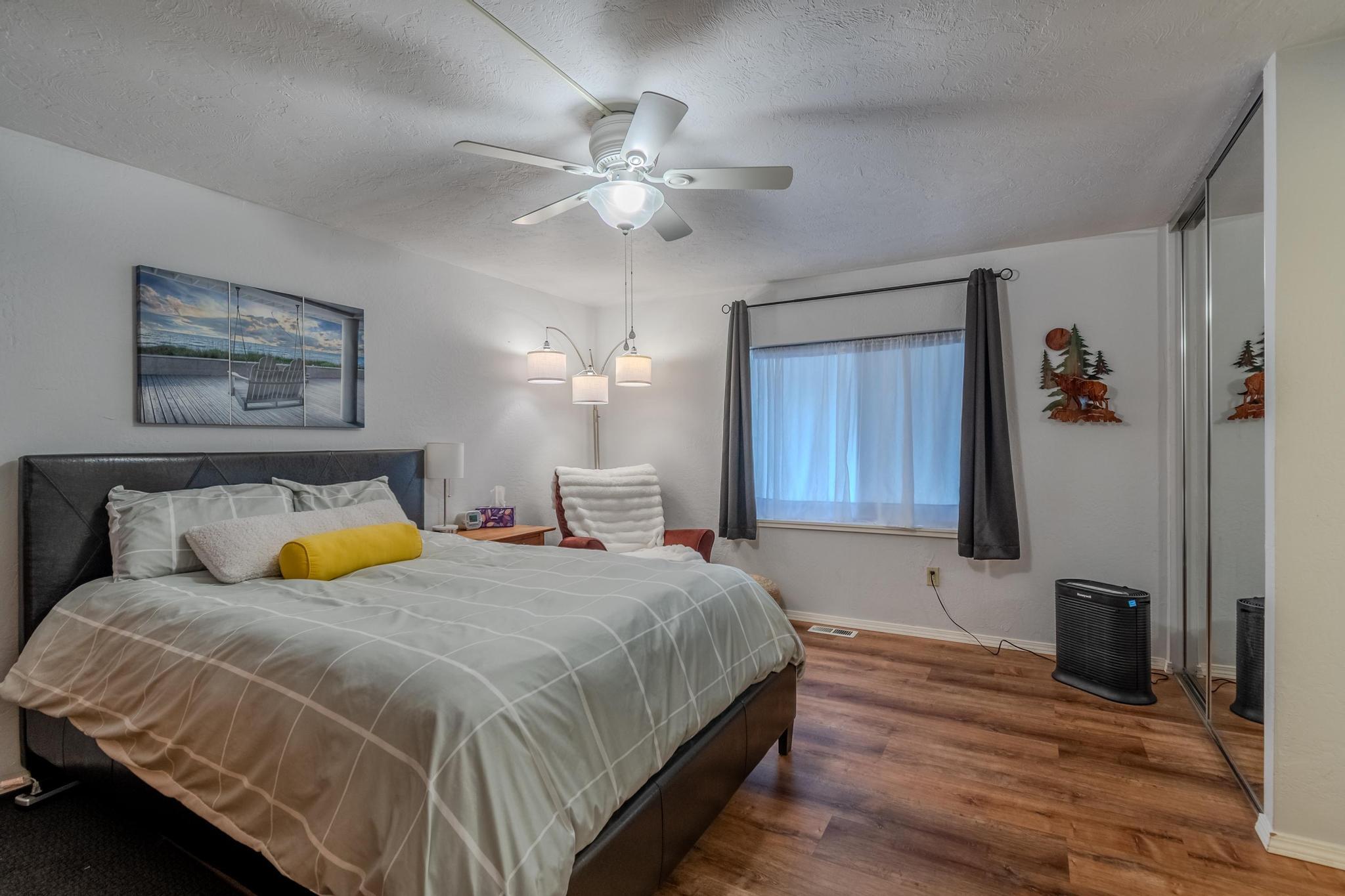 215 Tolman Creek Road, Unit SPC 11 Ashland, OR 97520 - Photo 14 of 36 a bedroom with a bed and a chandelier