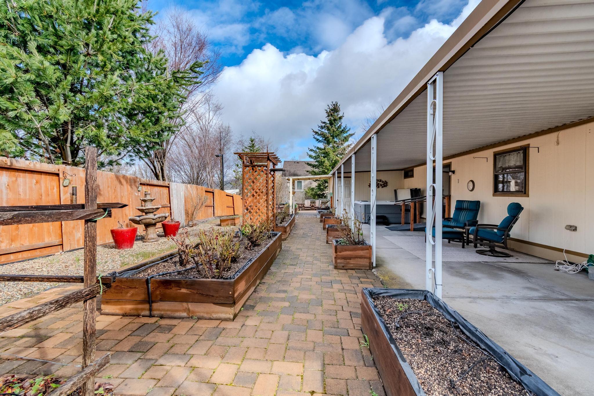215 Tolman Creek Road, Unit SPC 11 Ashland, OR 97520 - Photo 21 of 36 an outdoor space with lots of potted plants
