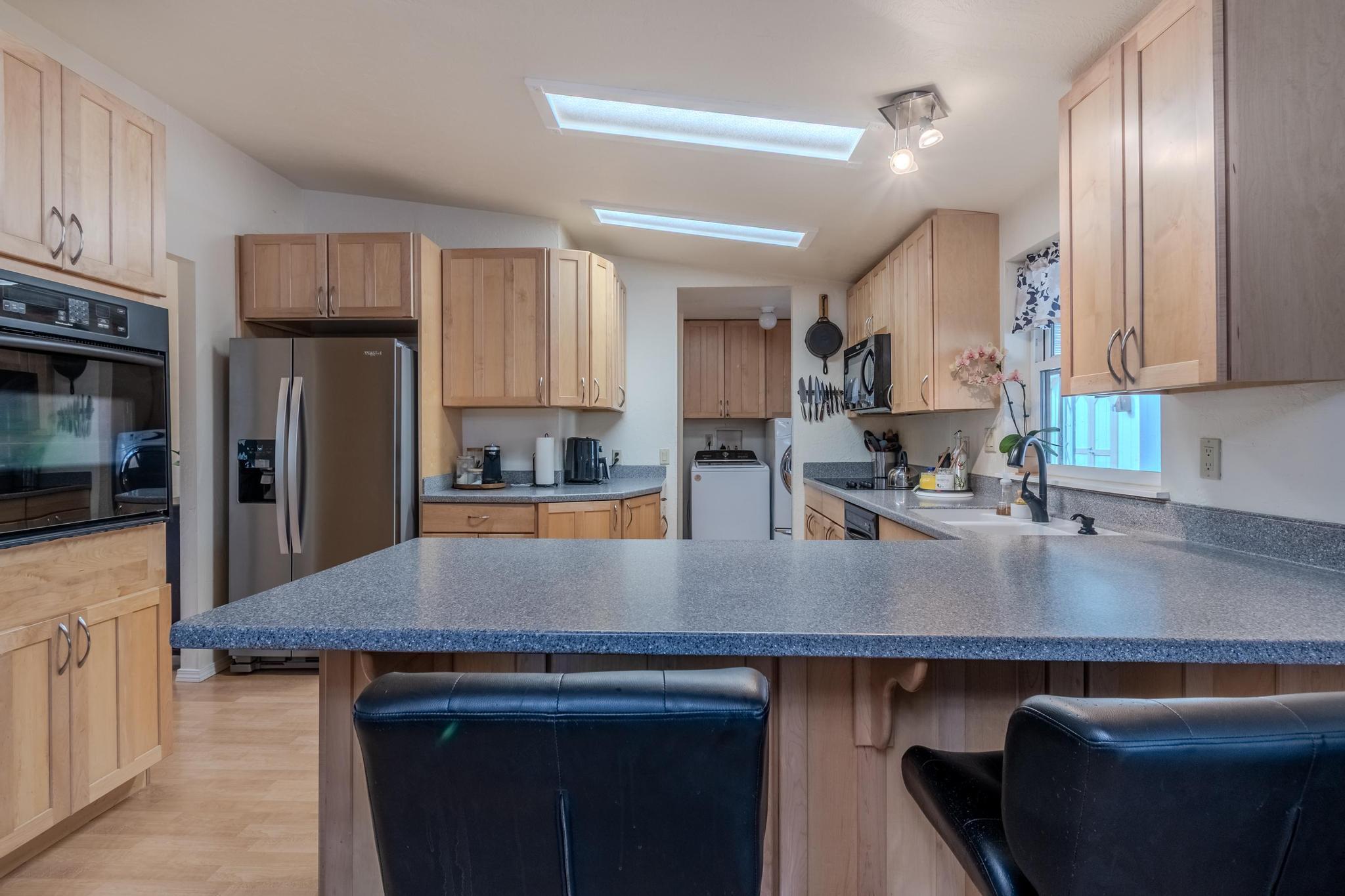 215 Tolman Creek Road, Unit SPC 11 Ashland, OR 97520 - Photo 7 of 36 a view of a kitchen counter top space a sink stainless steel appliances and cabinets