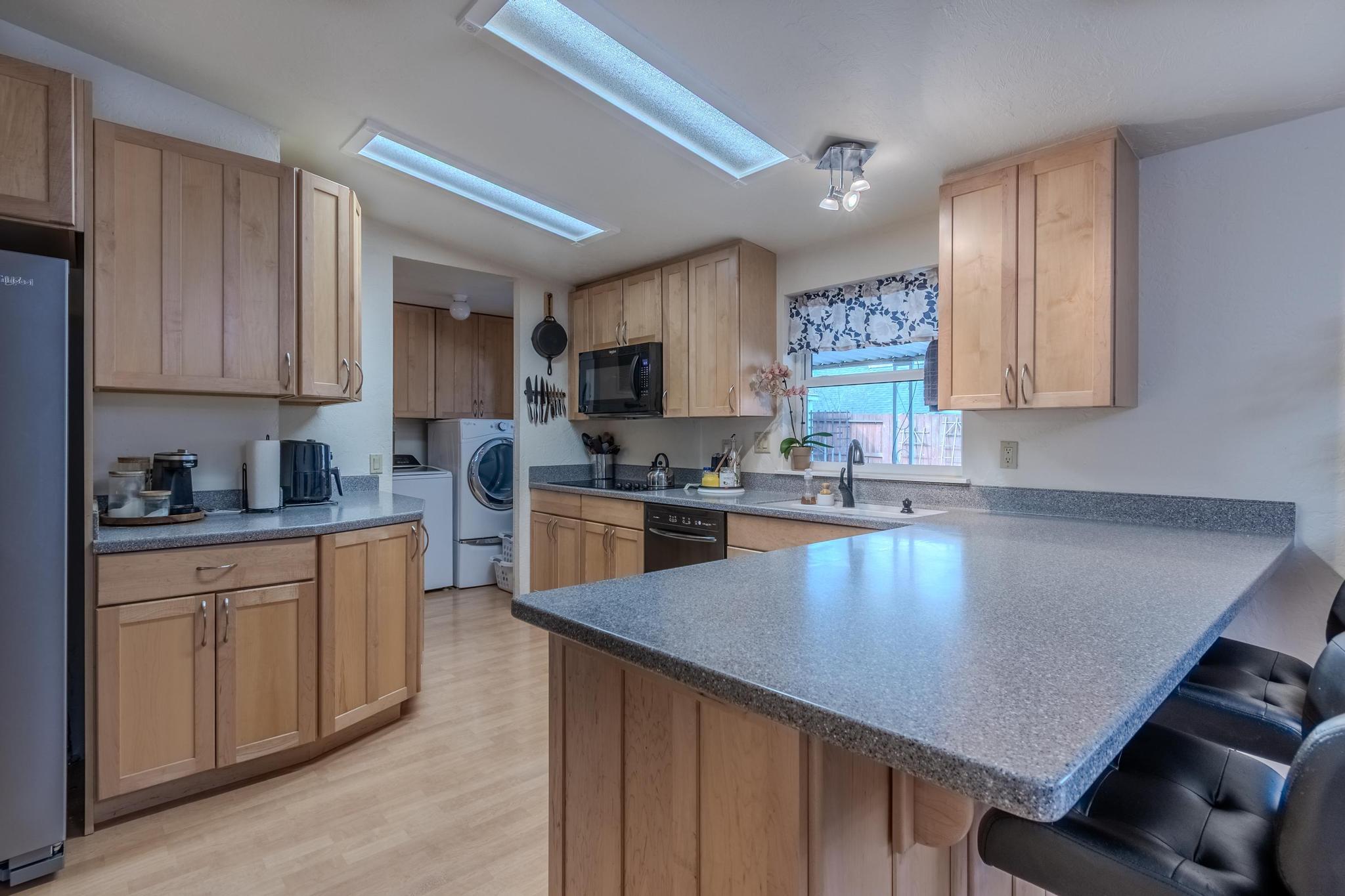 215 Tolman Creek Road, Unit SPC 11 Ashland, OR 97520 - Photo 8 of 36 a kitchen with stainless steel appliances granite countertop a sink refrigerator stove and microwave