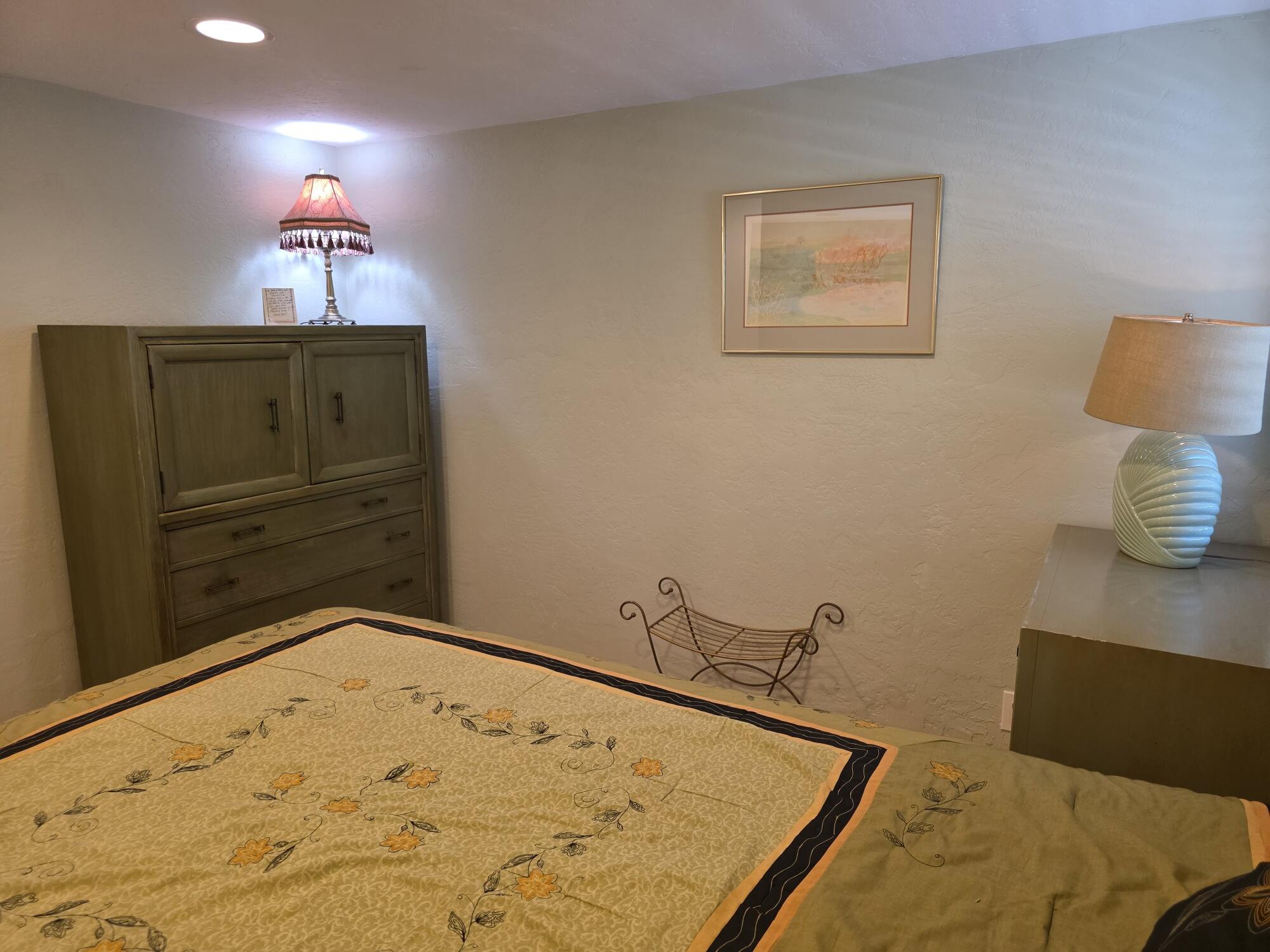 10595 Hot Mineral Spa Road, Unit 235 Niland, CA 92257 - Photo 16 of 45 a bedroom with a bed and a lamp on dresser