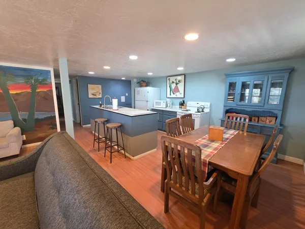 a living room with furniture and a dining table with kitchen view