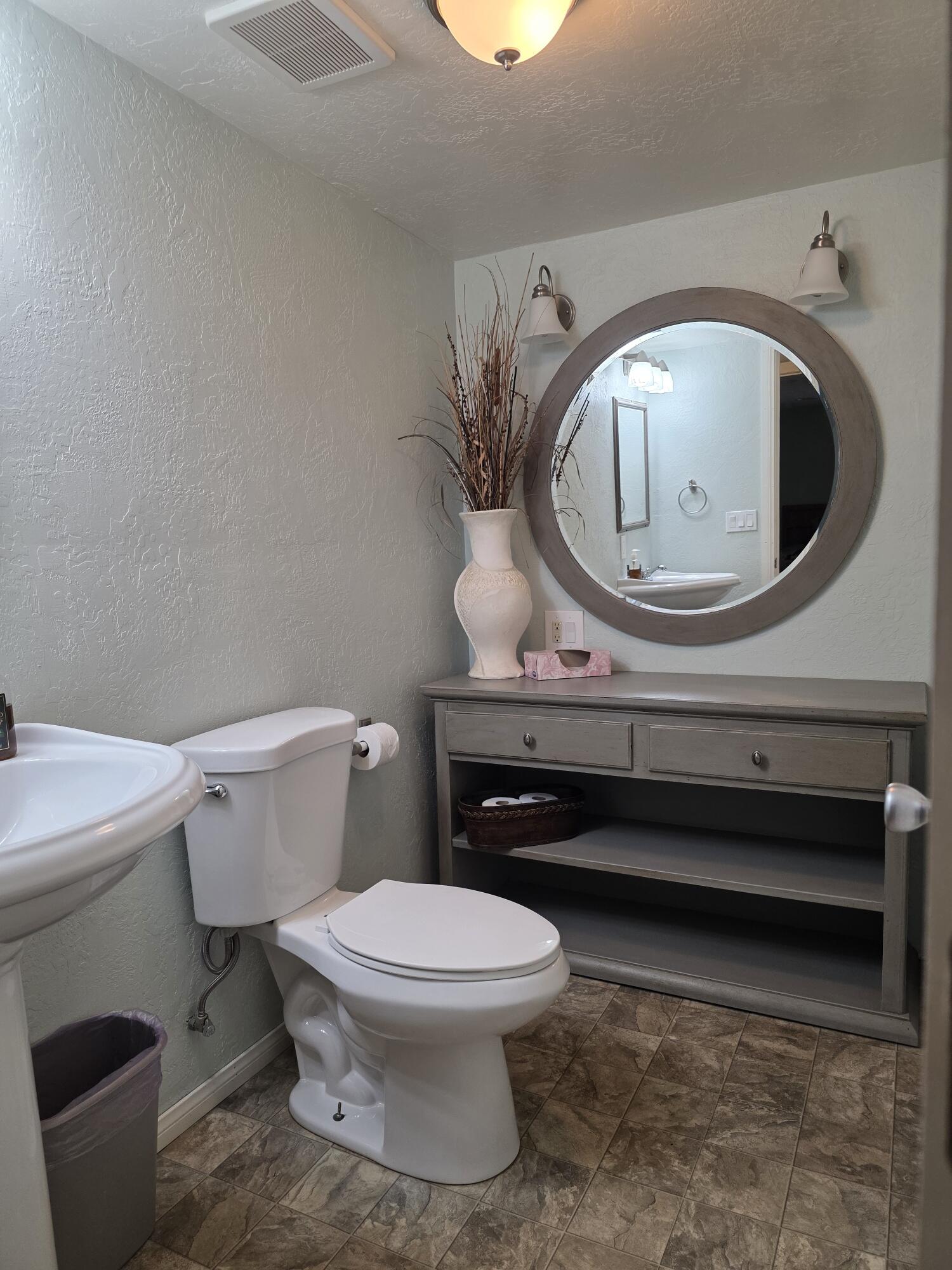 10595 Hot Mineral Spa Road, Unit 235 Niland, CA 92257 - Photo 22 of 45 a bathroom with a toilet a sink and a mirror