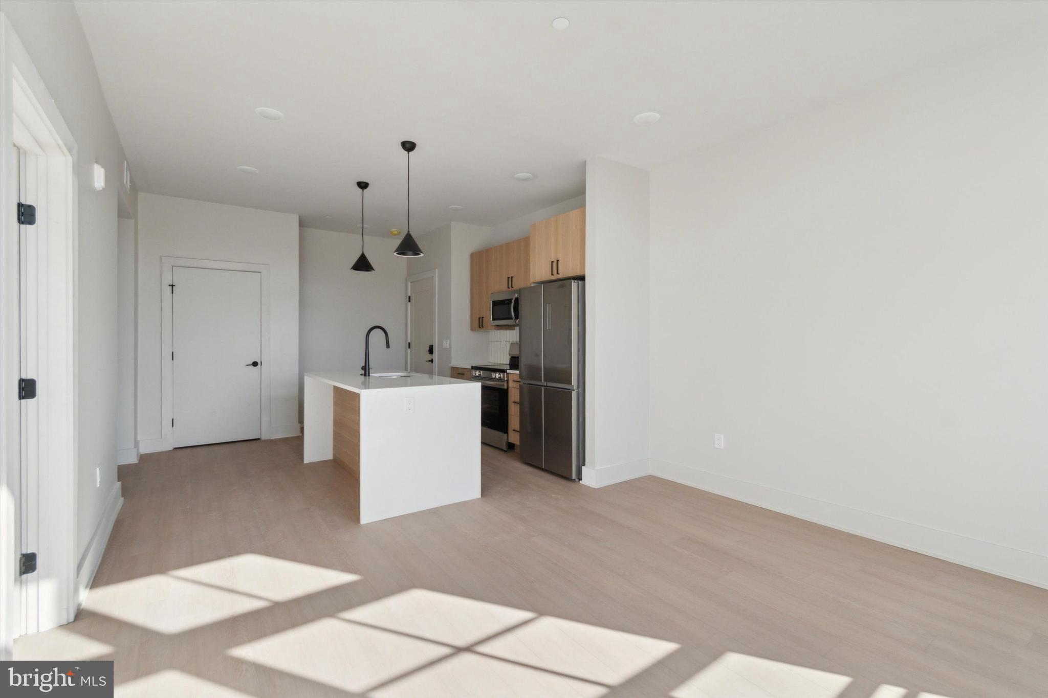 5521 Wayne Avenue, Unit 305 Philadelphia, PA 19144 - Photo 11 of 11 a view of a kitchen with wooden floor and a sink