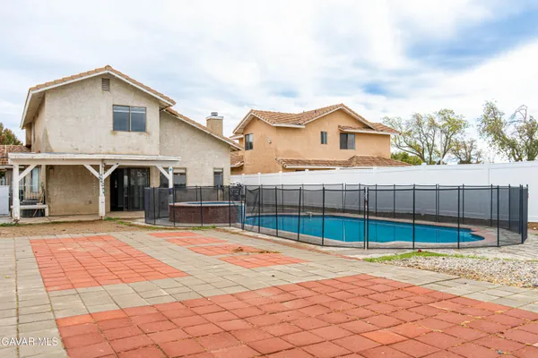 a view of a house with a backyard and a garage