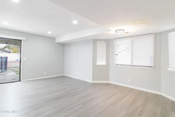 a view of an empty room with wooden floor