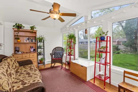 a living room with furniture and a floor to ceiling window