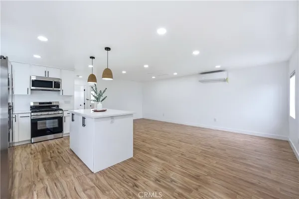 a kitchen with granite countertop a stove and a sink