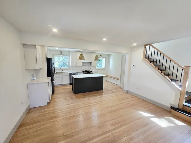 a view of kitchen with wooden floor and electronic appliances
