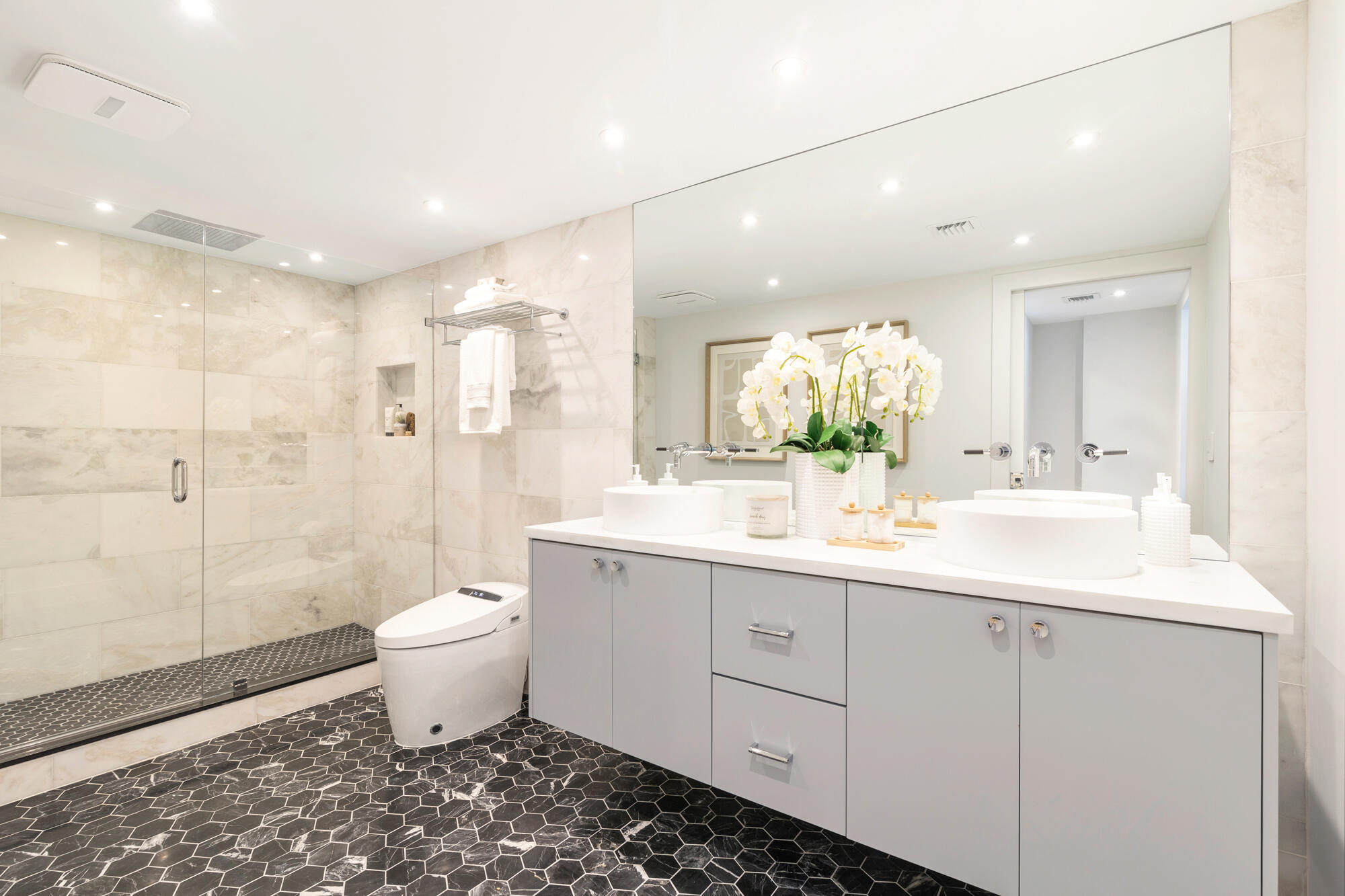 2773 South Ocean Boulevard, Unit 505 Palm Beach, FL 33480 - Photo 13 of 32 a bathroom with a double vanity sink toilet and shower