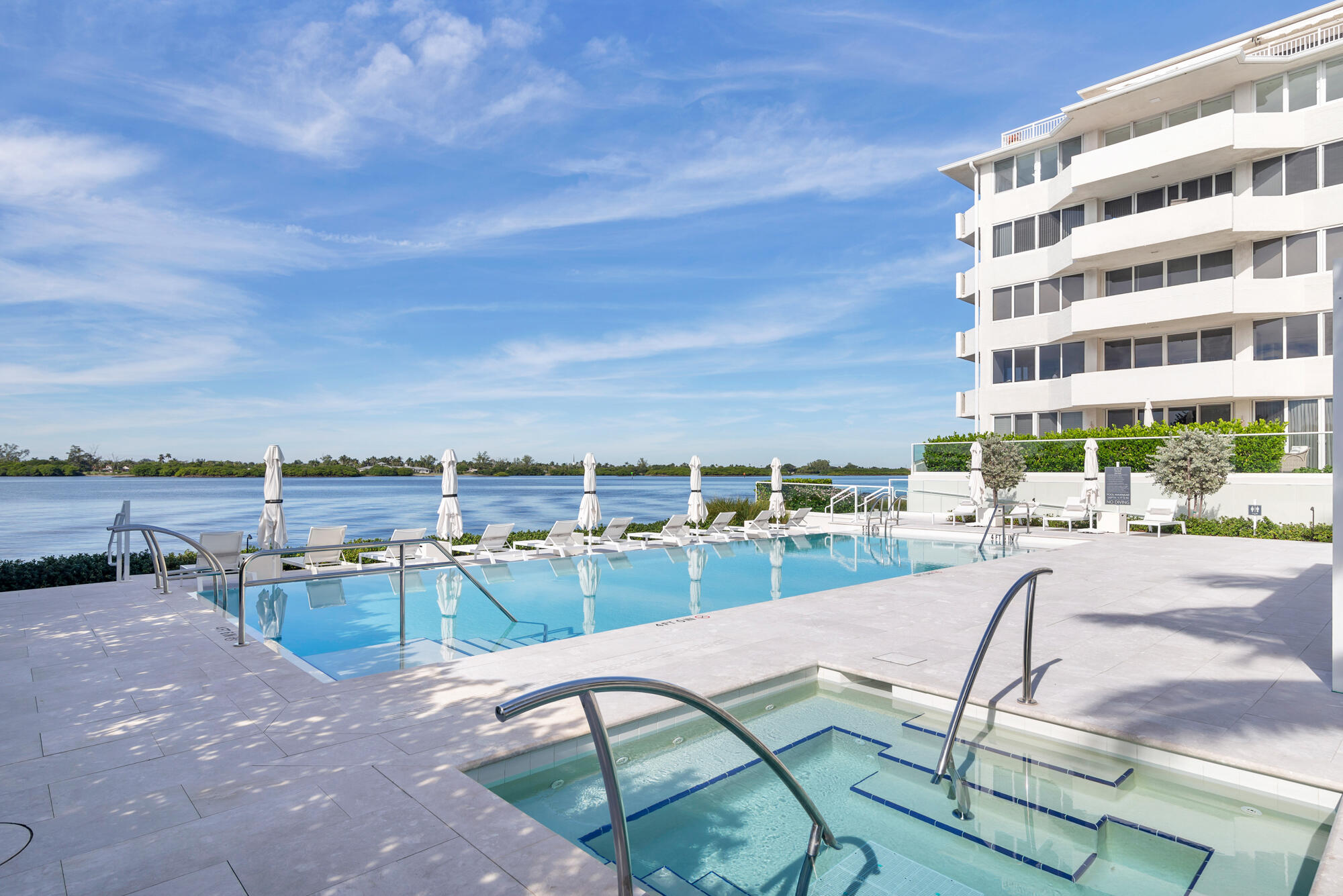 2773 South Ocean Boulevard, Unit 505 Palm Beach, FL 33480 - Photo 20 of 32 a view of a swimming pool with outdoor seating and a buildings