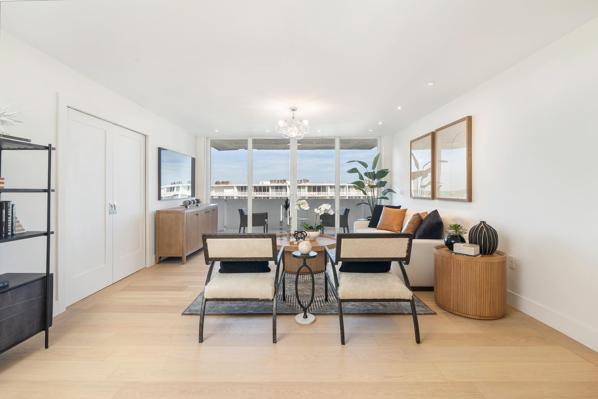 2773 South Ocean Boulevard, Unit 505 Palm Beach, FL 33480 - Photo 4 of 32 a living room with furniture and a chandelier