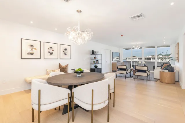 a view of a dining room with furniture and chandelier