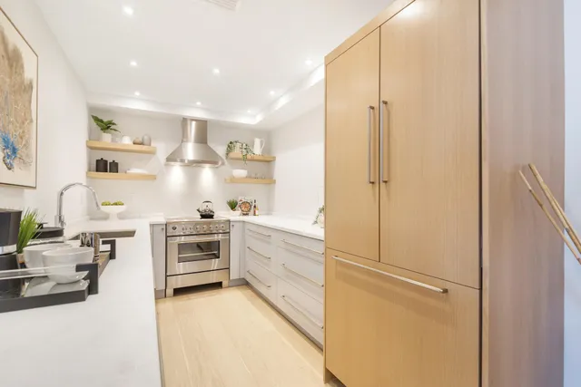 a kitchen with white cabinets and white appliances