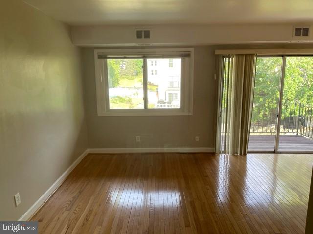 17 Water Street, Unit 22 Gaithersburg, MD 20877 - Photo 3 of 9 an empty room with wooden floor and windows