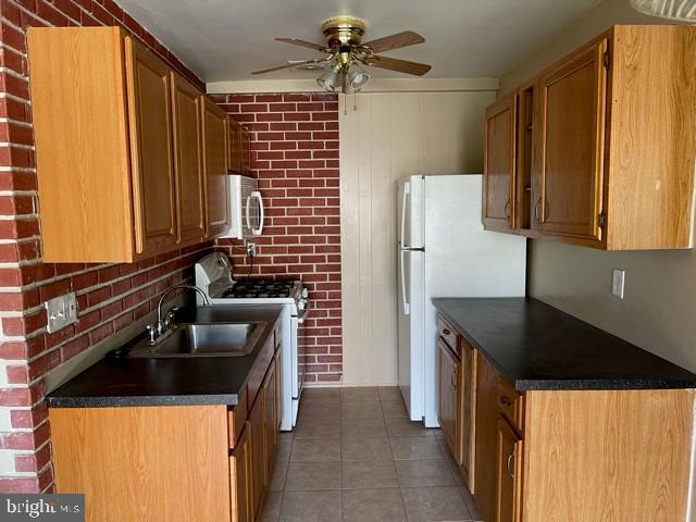 17 Water Street, Unit 22 Gaithersburg, MD 20877 - Photo 4 of 9 a kitchen with a sink and a refrigerator
