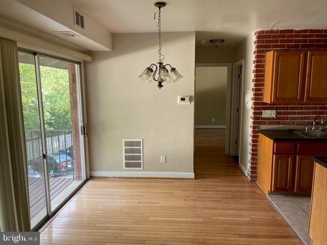 17 Water Street, Unit 22 Gaithersburg, MD 20877 - Photo 5 of 9 a view of a hallway with wooden floor and a cabinet
