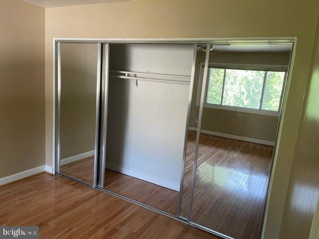 17 Water Street, Unit 22 Gaithersburg, MD 20877 - Photo 6 of 9 an empty room with wooden floor cabinet and windows