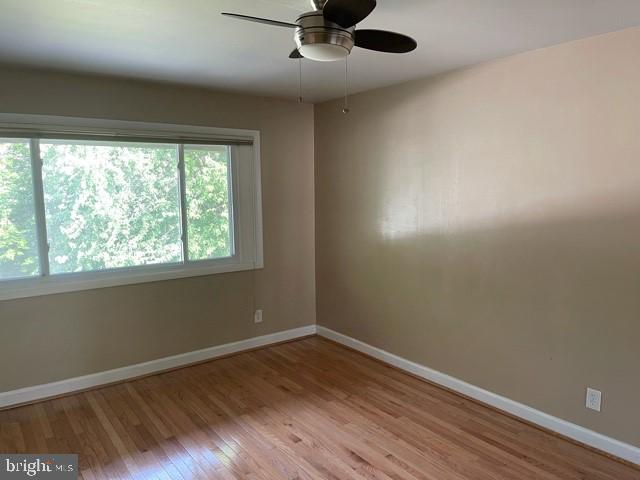 17 Water Street, Unit 22 Gaithersburg, MD 20877 - Photo 7 of 9 wooden floor in an empty room with a window