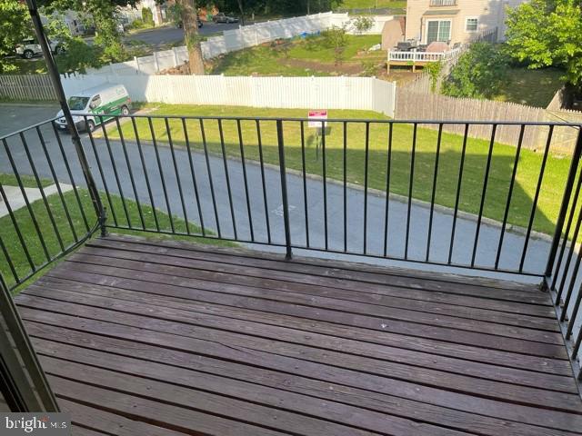 17 Water Street, Unit 22 Gaithersburg, MD 20877 - Photo 9 of 9 a view of a balcony with floor to ceiling windows with wooden floor