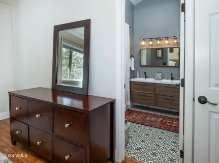a kitchen with a wooden floor and cabinets