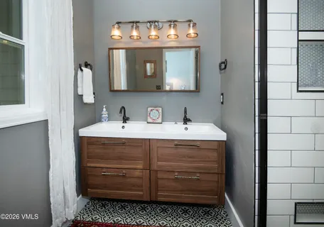 a bathroom with a sink and a mirror