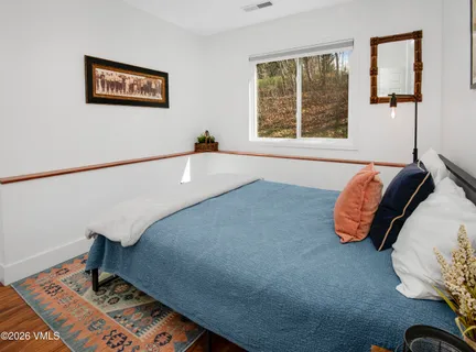 a bedroom with a bed and a window