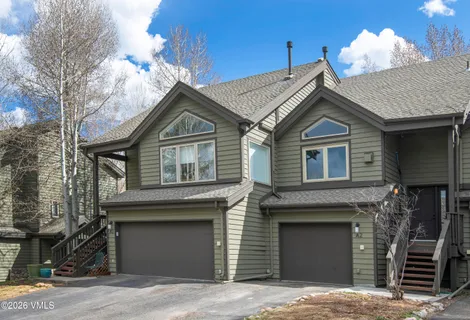 a front view of a house with a garage and a yard