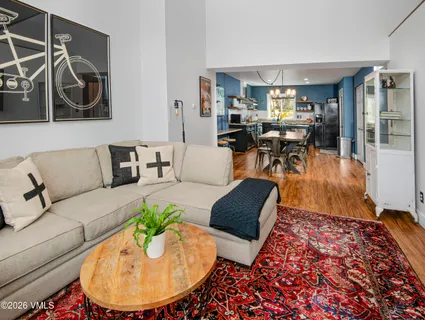 a living room with furniture and a wooden floor