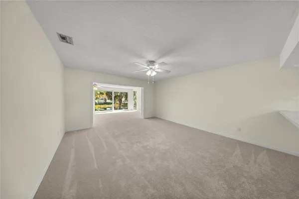 a view of an empty room with a window