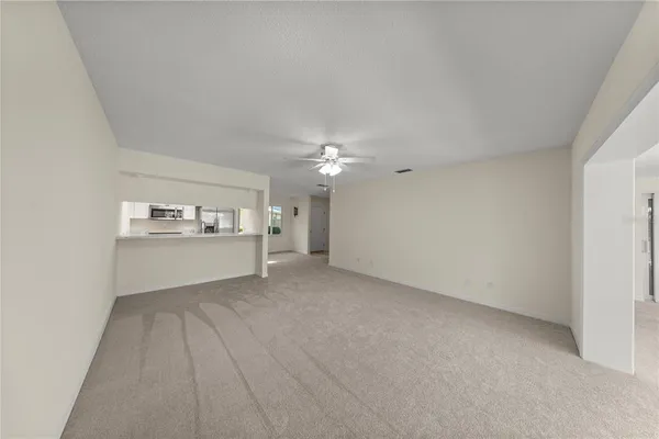 a view of a kitchen with faucet and cabinets